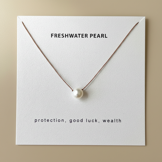 Pearl necklace on card with neutral background