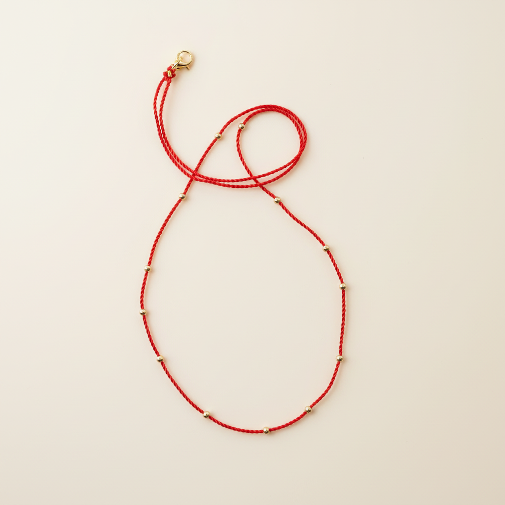 Red cord necklace with neutral background